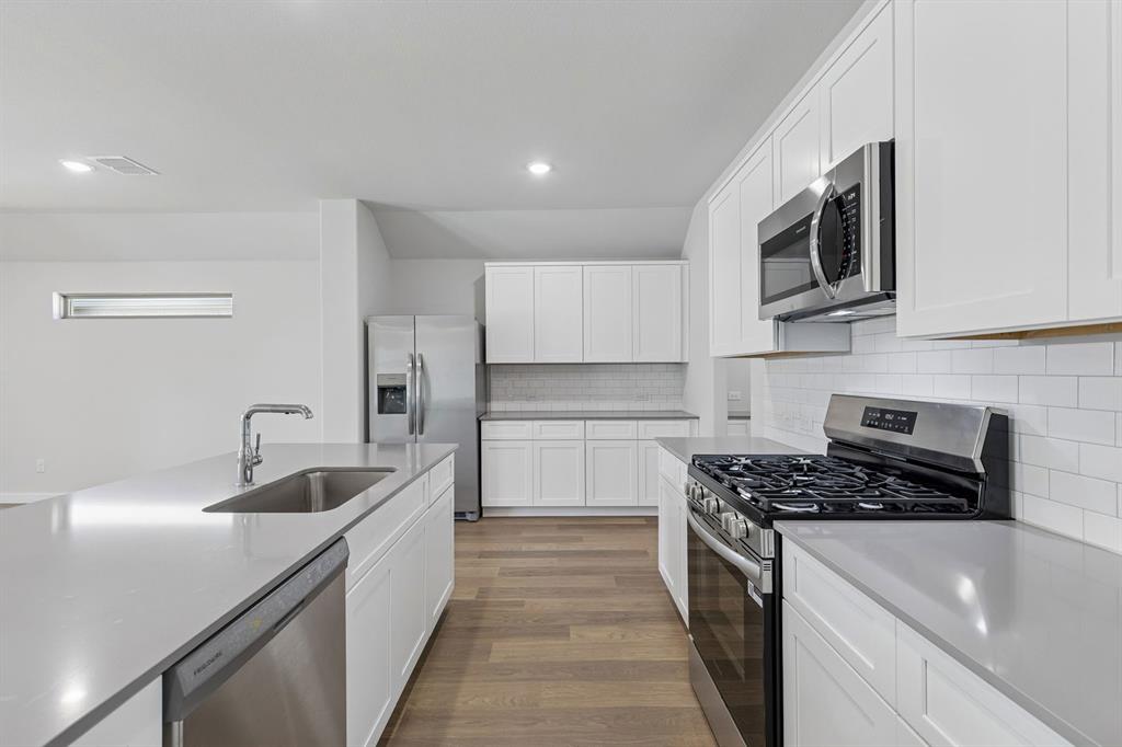 Kitchen in the Harrison home plan by Trophy Signature Homes – REPRESENTATIVE PHOTO