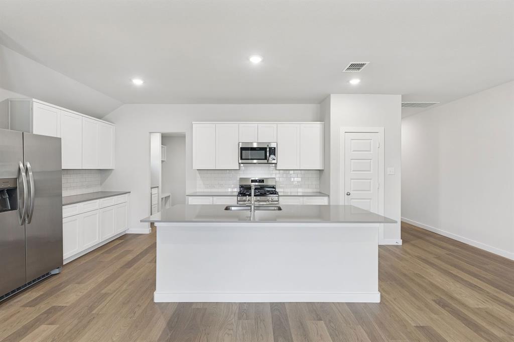 Kitchen in the Harrison home plan by Trophy Signature Homes – REPRESENTATIVE PHOTO