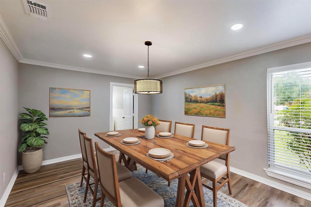 *Virtually staged*  Dining room with wood finished floors, baseboards, ornamental molding, and recessed lighting