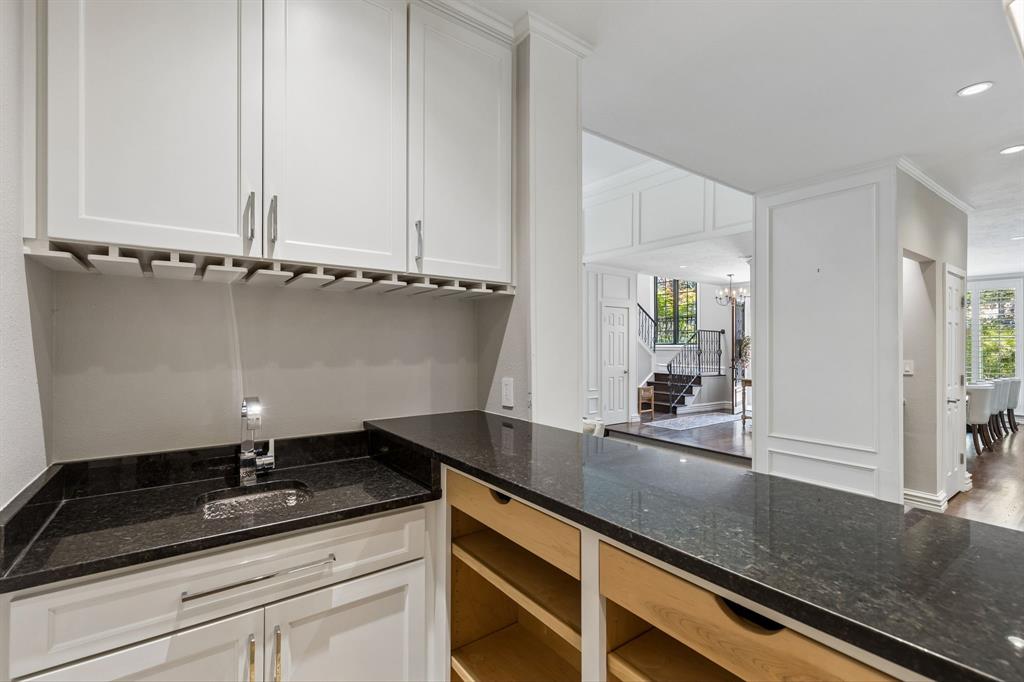 Wet bar with built-in storage adds to the entertaining aesthetic of this home.