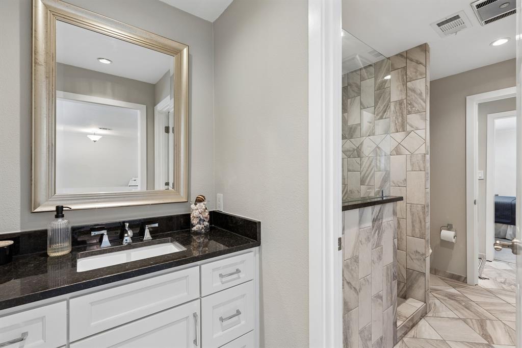 Another beautifully updated bathroom with pocket doors connecting for privacy.