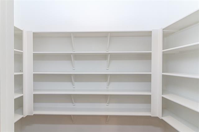 Built-in shelving system featuring multiple white shelves and vertical supports
