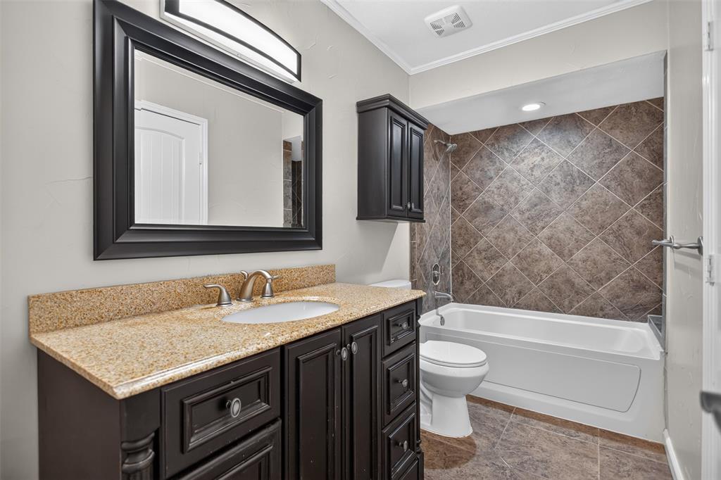 Primary bath boasts of tile surround and granite counter top.