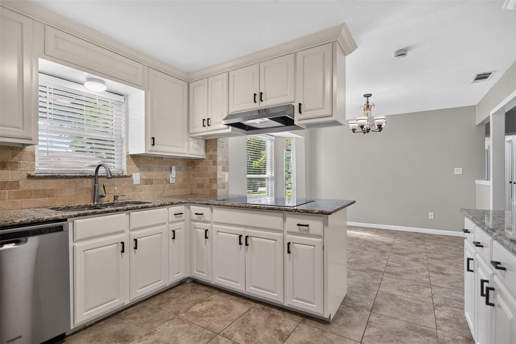 Bright white kitchen with granite counter tops.