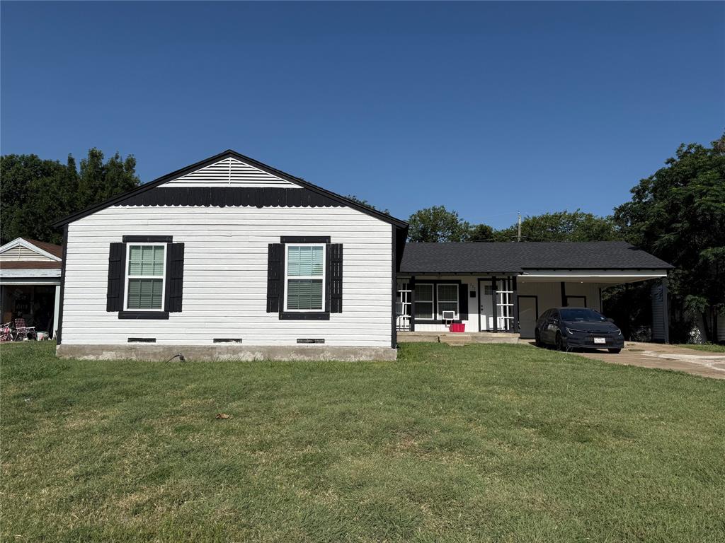 Single-story residence featuring white siding and a contrasting black roof