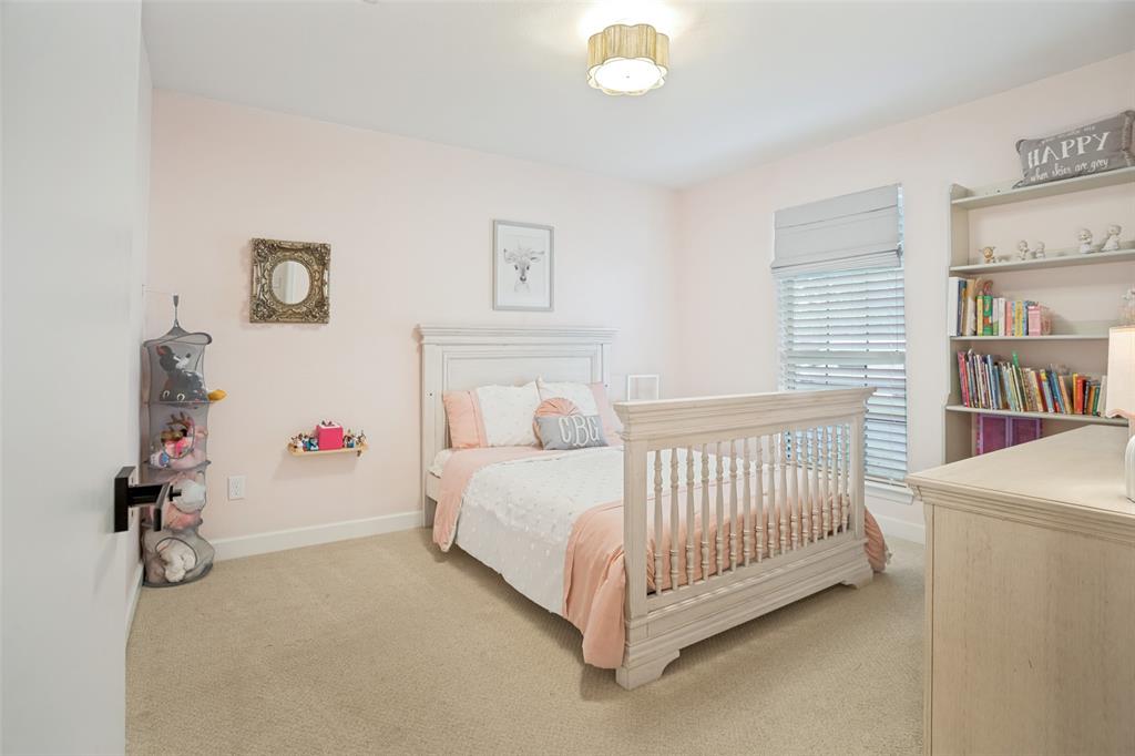 Bedroom featuring neutral carpet flooring and a built-in shelving unit