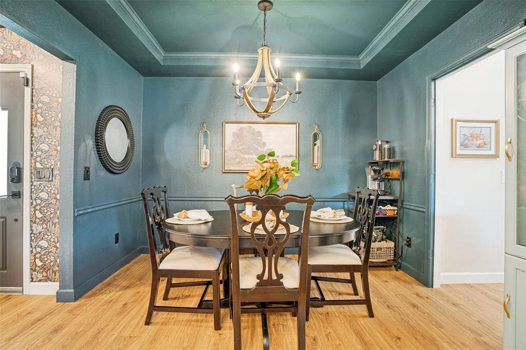 Dining area featuring wood-finish flooring and a coffered ceiling