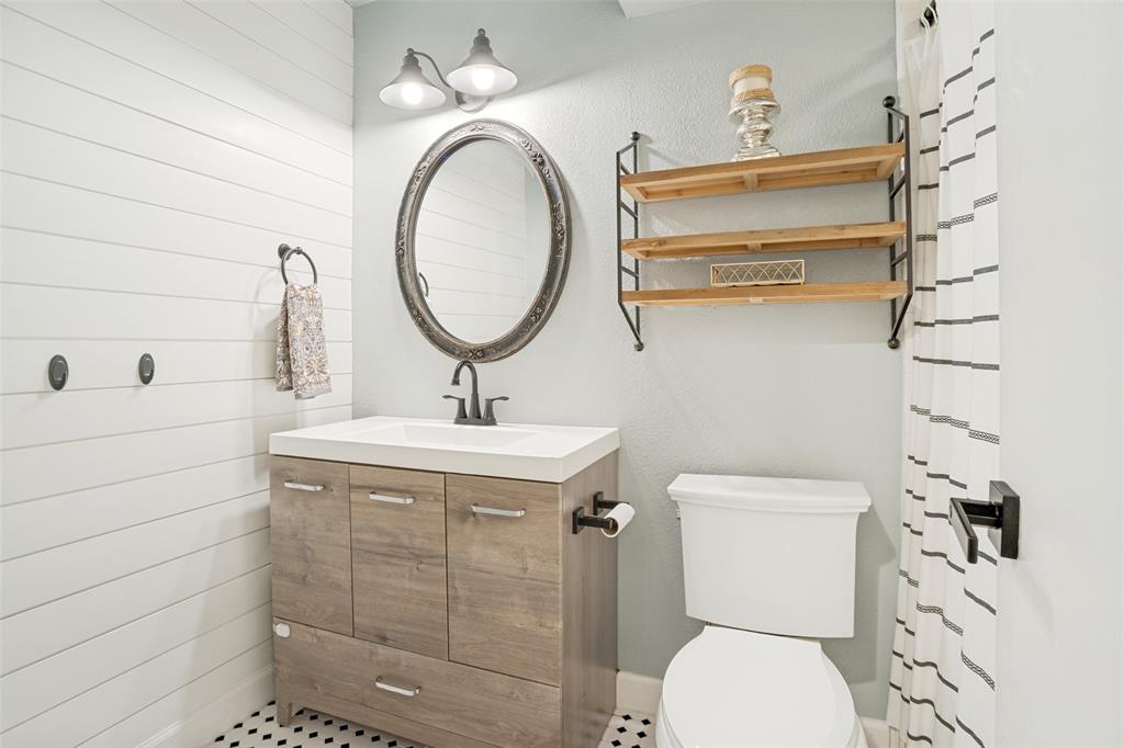 Bathroom vanity with a white countertop and wood-finish cabinetry
