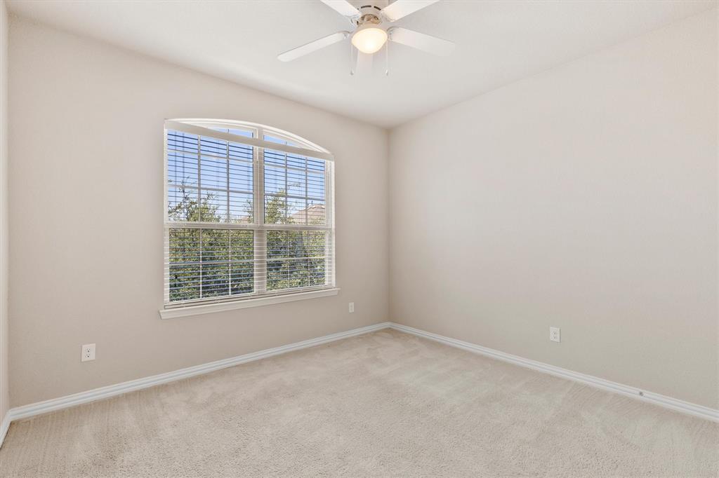 Open-concept living area featuring wood-finish flooring, a tray ceiling with a ceiling fan, and recessed lighting