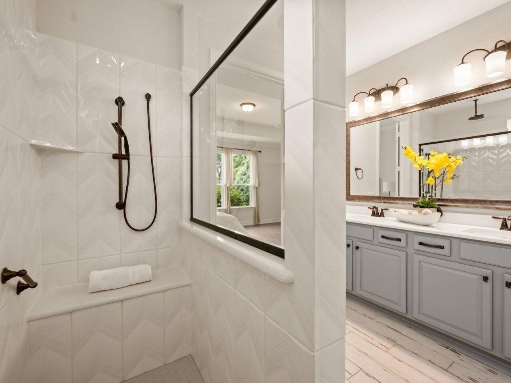 Huge walk-in shower with body sprayer and ceiling rain fixture