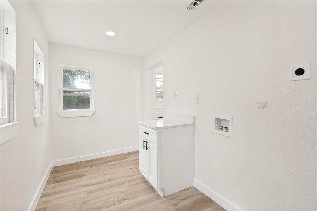 Utility space featuring light wood-finish flooring, white walls, and recessed lighting