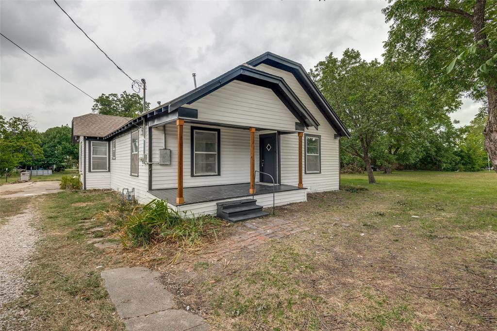 White siding exterior with a dark trim roofline White siding exterior with a dark trim roofline