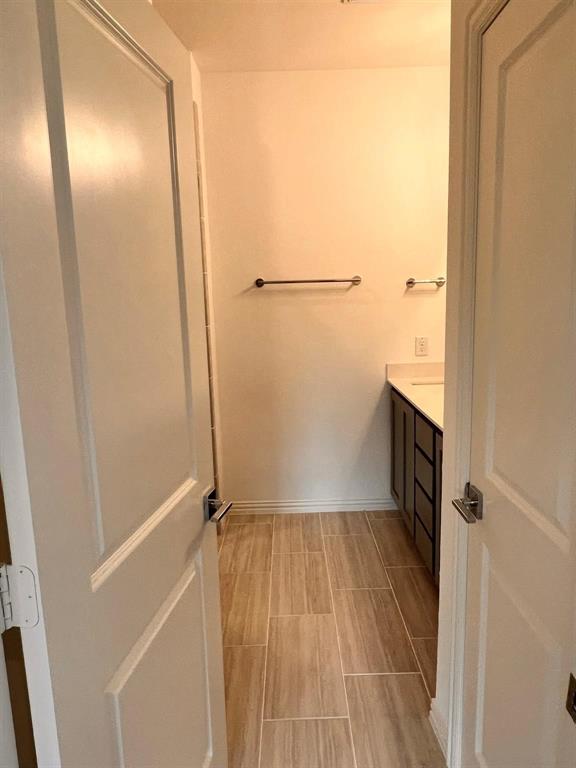 Neutral-toned ceramic tile flooring, white baseboards, and light wall finishes
