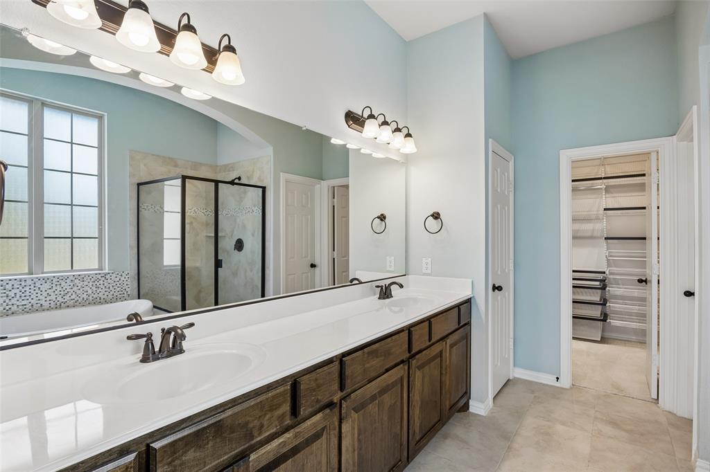 Double vanity with white countertops and dark wood cabinetry