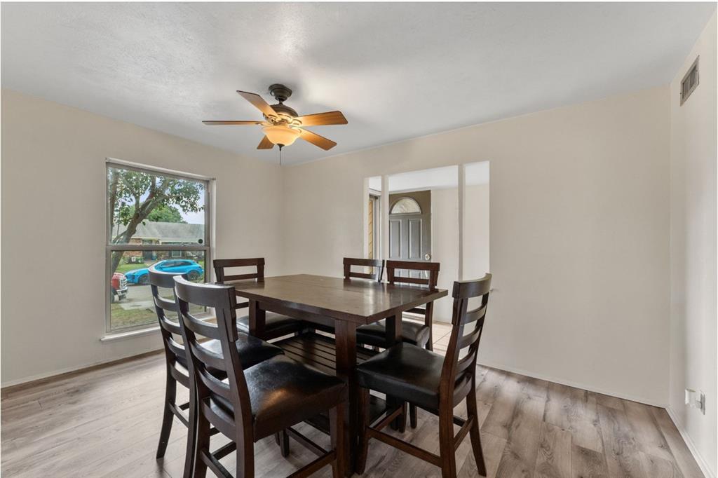 Wood-finish flooring, recessed lighting, and a ceiling fan with integrated lighting