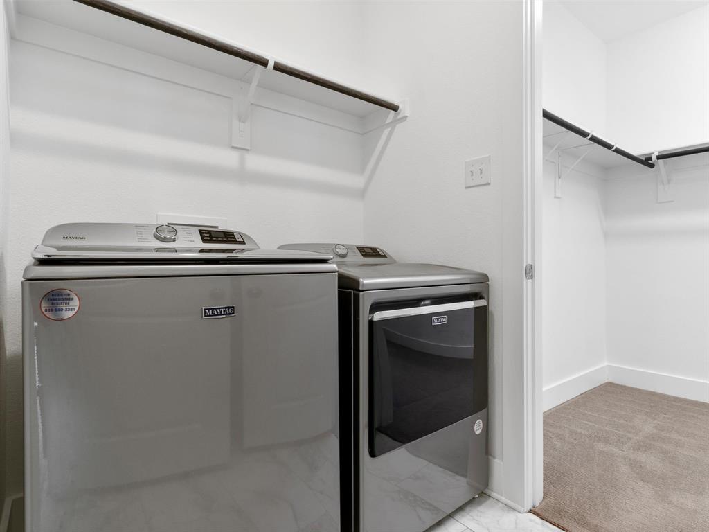 Laundry room with Maytag Appliances- conveniently located off primary closet.