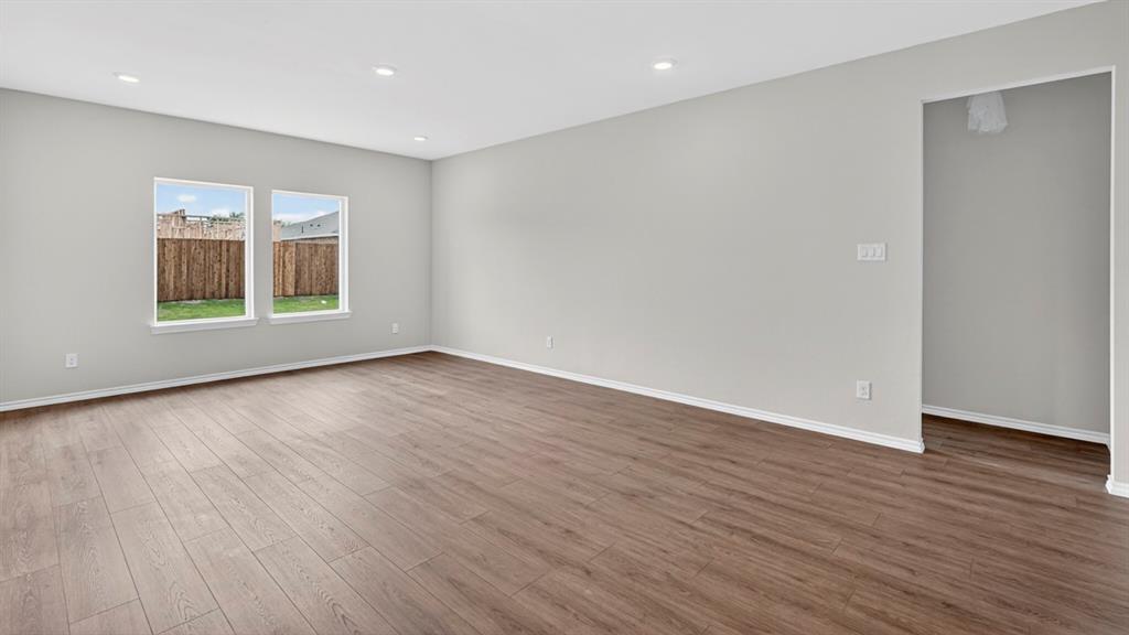 Spacious interior featuring wood-finish flooring, recessed lighting, and light gray walls