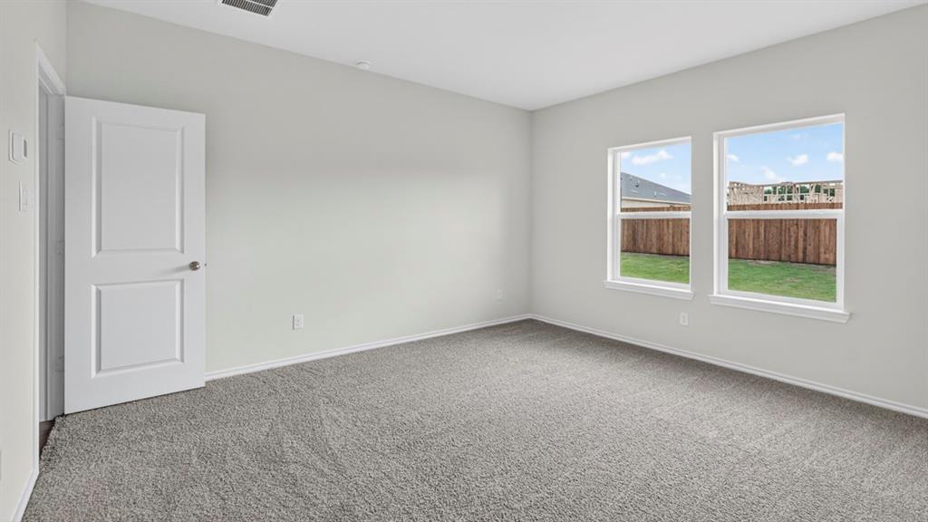 Carpeted room featuring light gray walls, white trim, and two paneled interior doors