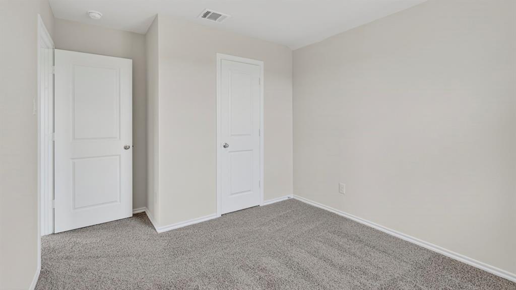 Neutral gray carpeting complements freshly painted light gray walls
