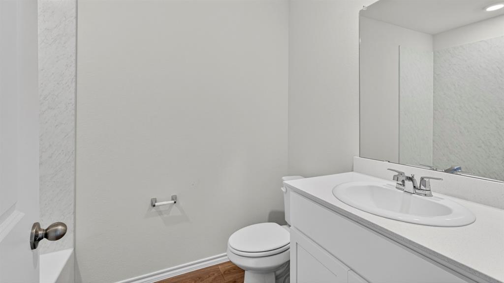 Bathroom vanity with integrated sink, chrome faucet, and expansive mirror