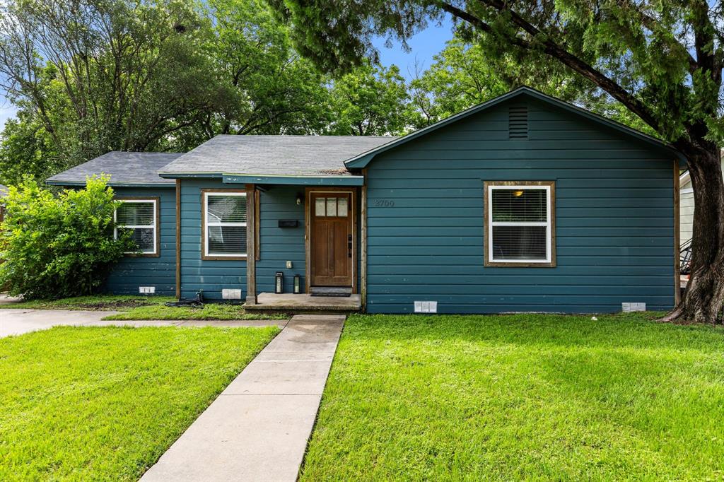 Charming residence featuring a rich blue exterior siding