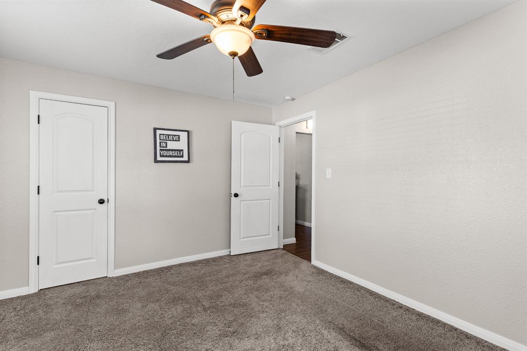 Interior room featuring plush gray carpeting and neutral wall tones