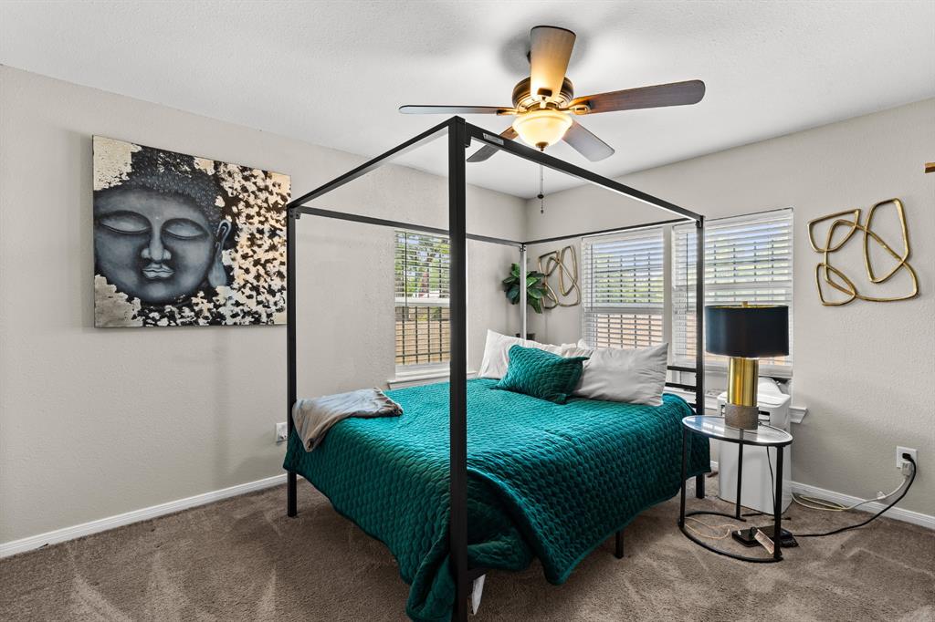 Spacious bedroom featuring neutral wall tones and plush carpeting Spacious bedroom featuring neutral wall tones and plush carpeting