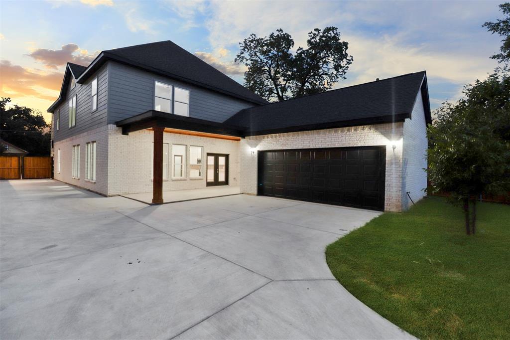 Modern two-story home featuring a striking black and white exterior with clean architectural lines