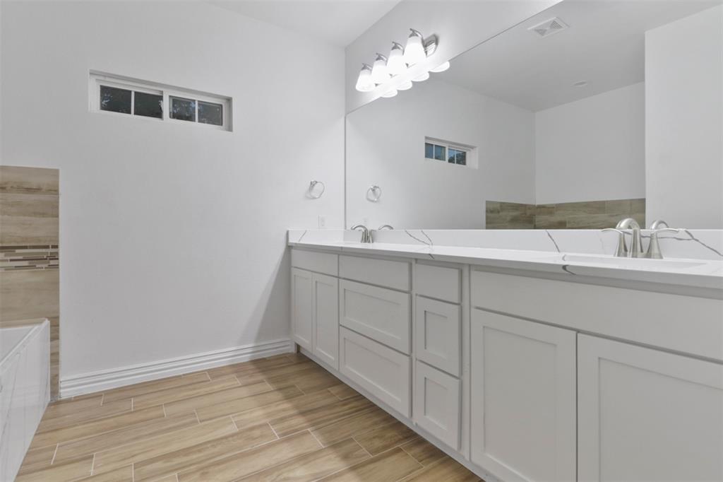 Spa-inspired primary bathroom featuring a double vanity with soft-close cabinetry, dual rectangular sinks, and polished chrome fixtures