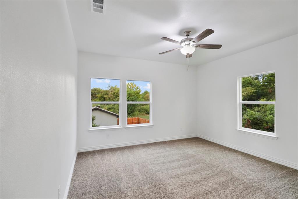 Bright interior space featuring light-toned carpeting and white painted walls