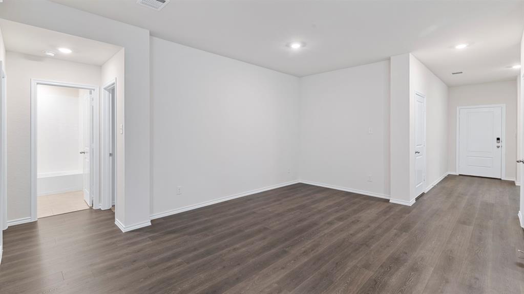 Open living area with wood-finish flooring and recessed lighting