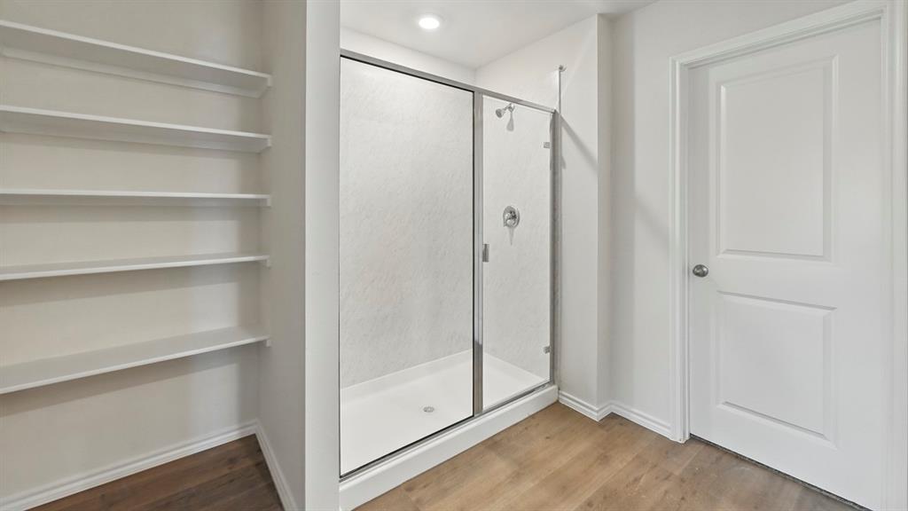 Walk-in shower with clear glass enclosure and chrome fixtures Walk-in shower with clear glass enclosure and chrome fixtures