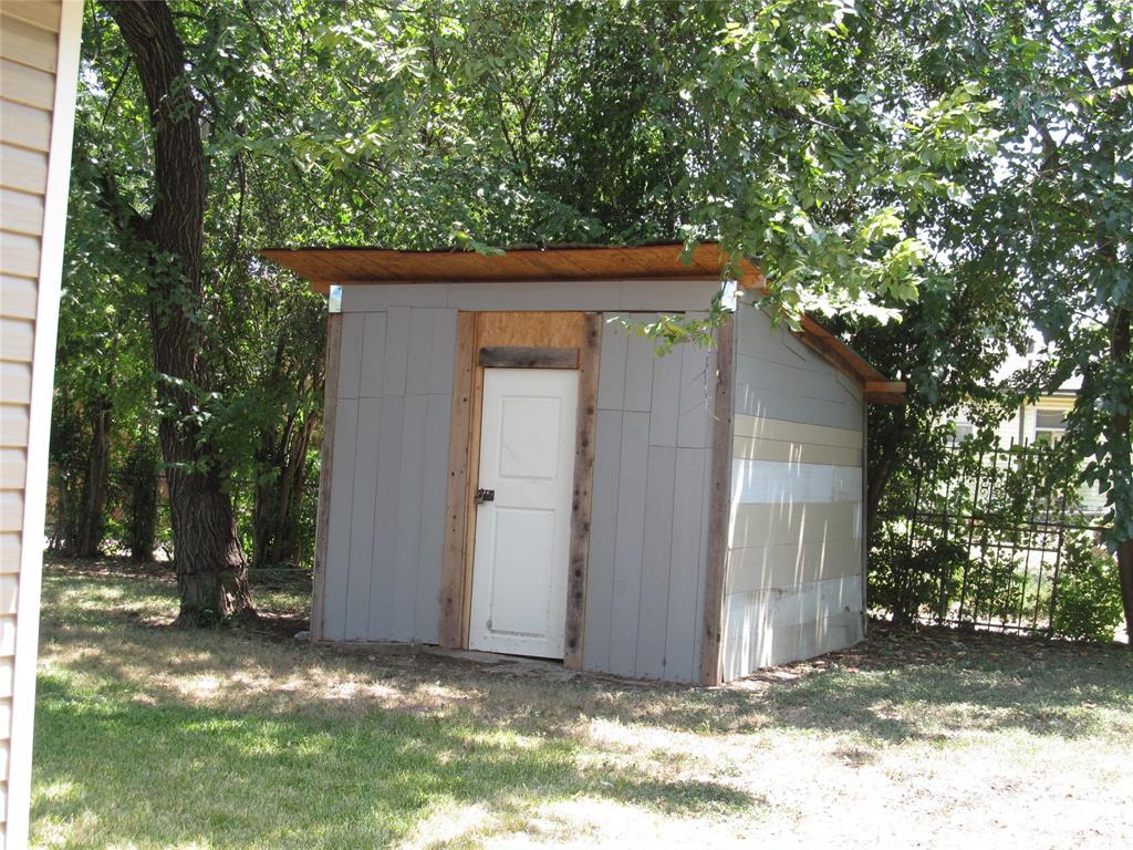 REAR VIEW OF THE BACK YARD WITH HAND BUILT SHED