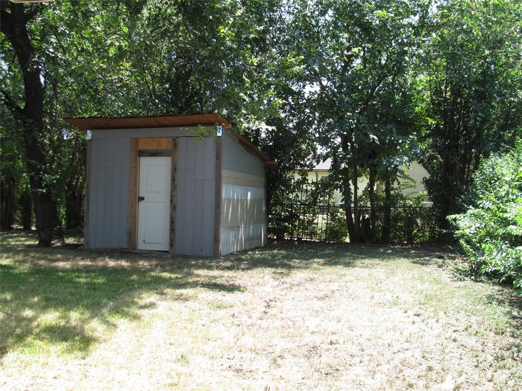 REAR RIGHT  VIEW OF THE BACK YARD   WITH HAND BUILT SHED VIEW - THERE IS AN ALLEY WAY BEHIND THE FENCE