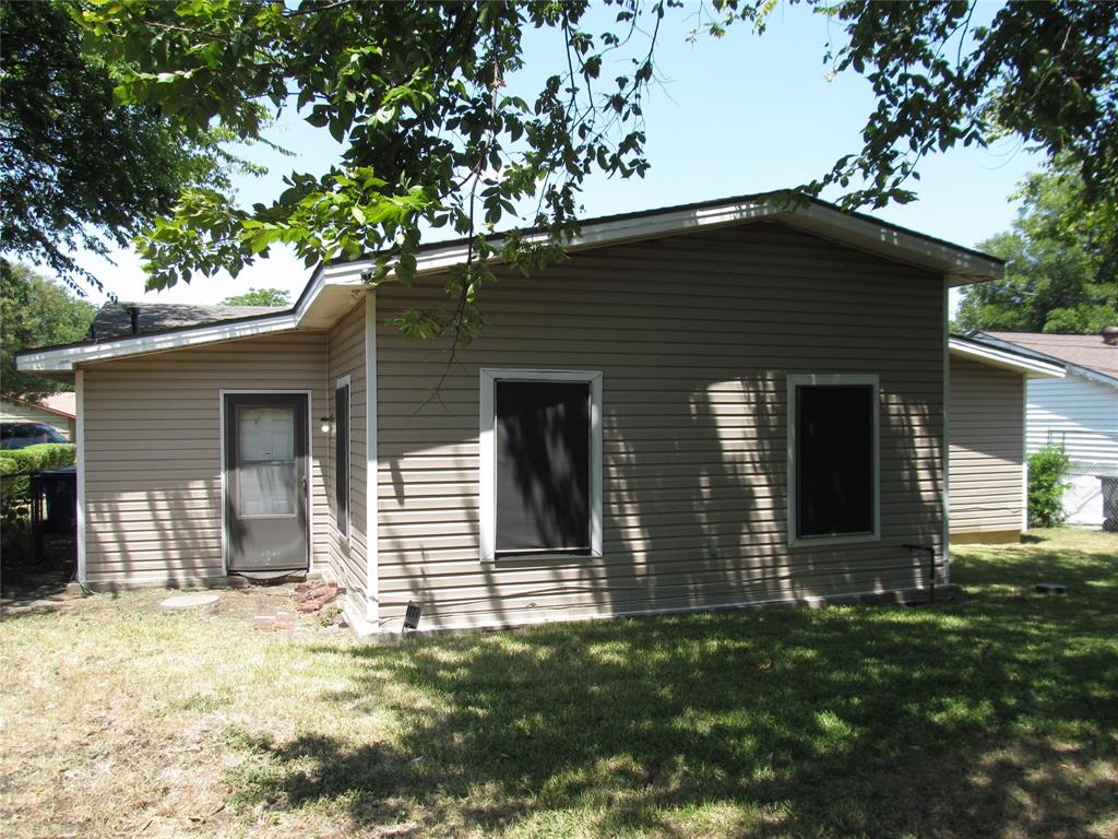 REAR LEFT VIEW OF BACK YARD WITH VIEW OF REAR BACK DOOR AND REAR OF HOME
