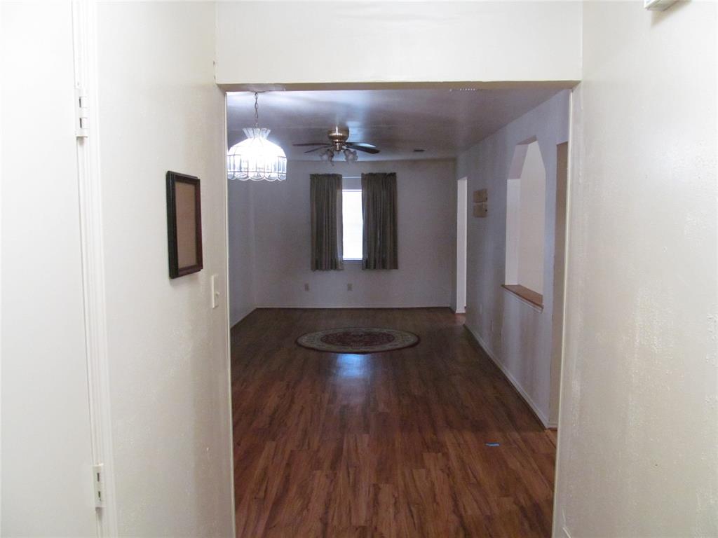 BACKDOOR VIEW OF HALLWAY LOOKING ON TO THE  FAMILY LIVING ROOM