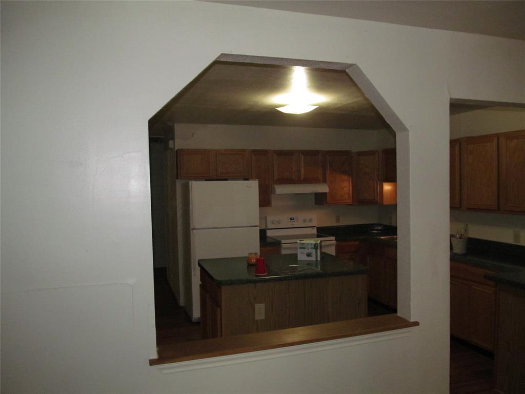 Kitchen pass-through with an arched opening and wood trim