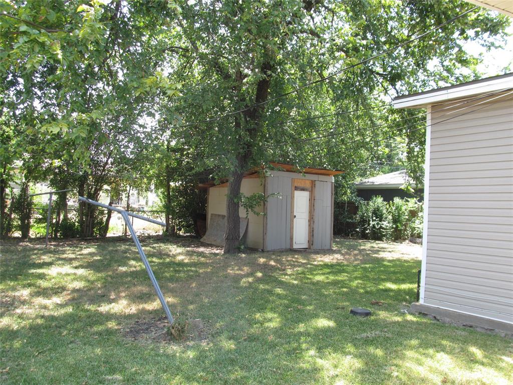 LEFT REAR VIEW OF THE BACK YARD WITH VIEW OF HAND BUILT SHED
