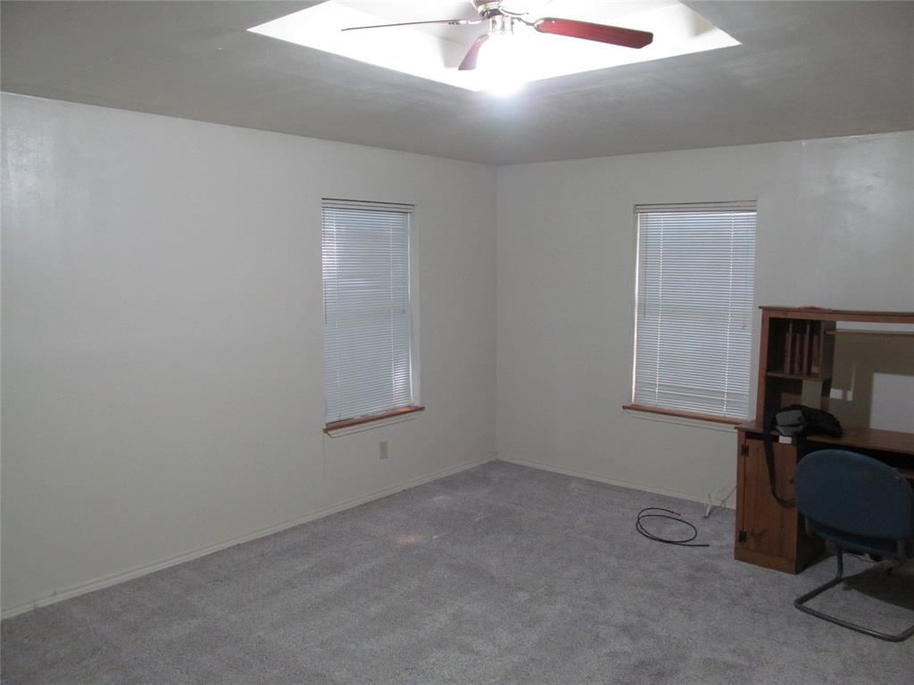 Recessed ceiling with integrated lighting, ceiling fan, two windows with blinds, and carpeted flooring- PRIMARY BEDROOM