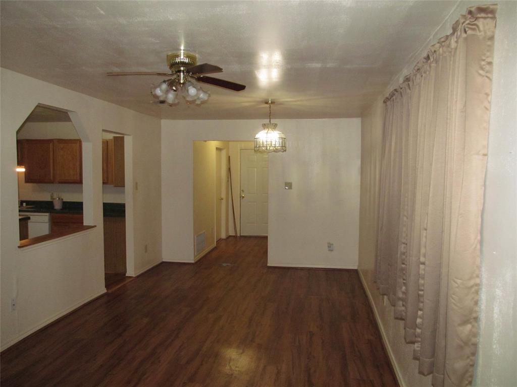 FAMILY LIVING ROOM OR DEN VIEW OF THE HALL WAY , BACK DOOR  AND PARTICAL KITHEN VIEW
