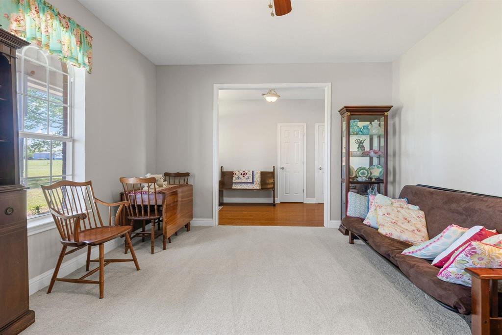Spacious room with light-toned wall paint and carpeted flooring