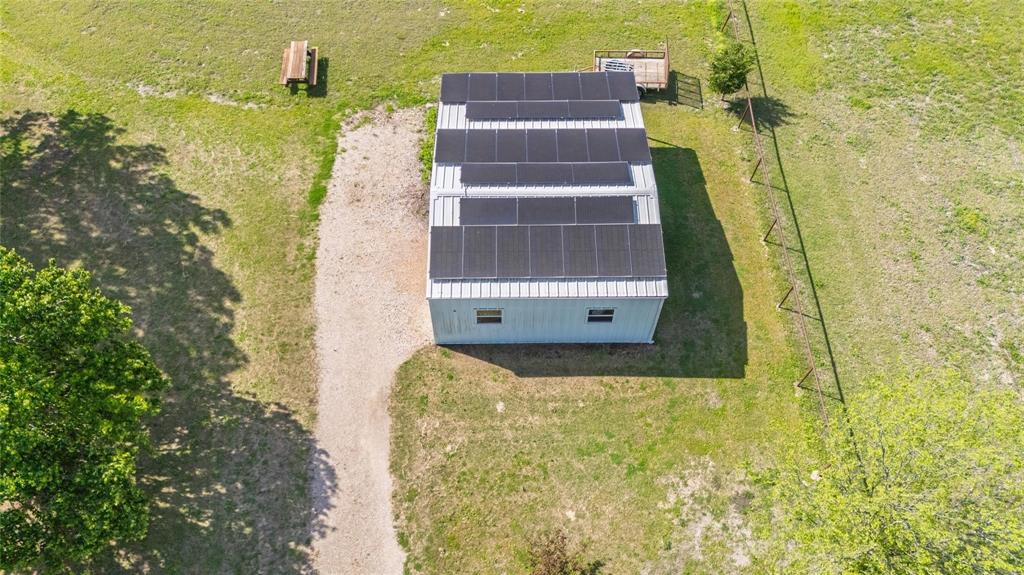 Building with a metal roof featuring multiple solar panel arrays