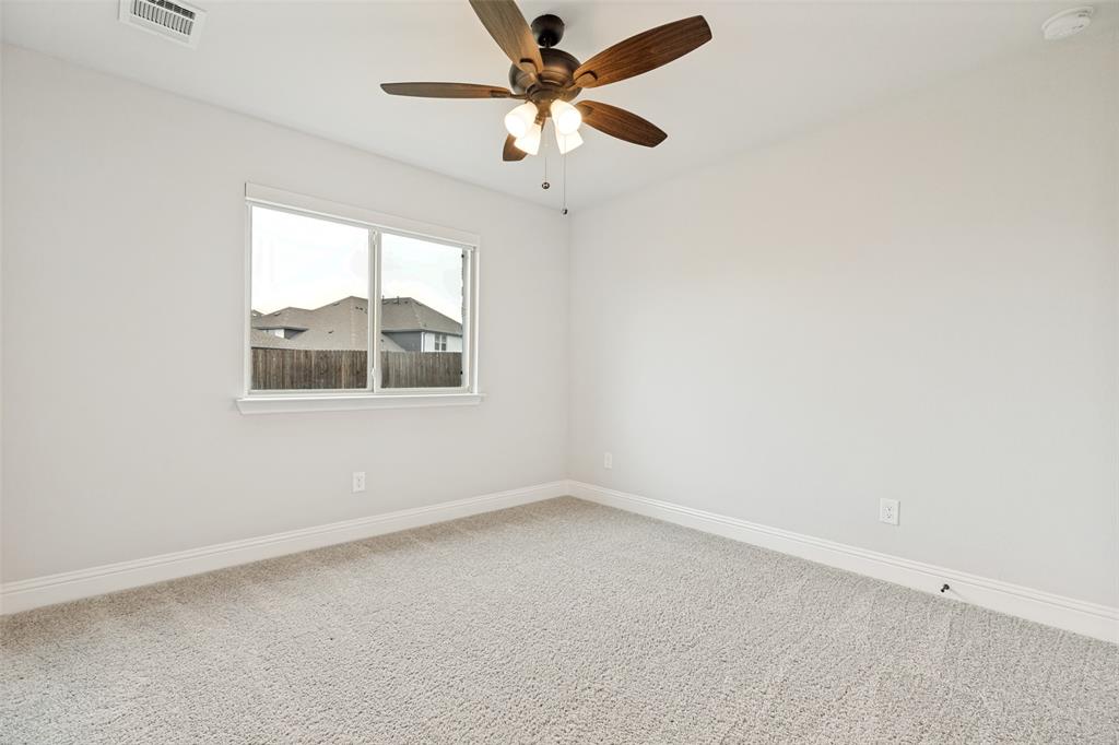 Carpeted room featuring a ceiling fan with integrated lighting, a single window, and white baseboards