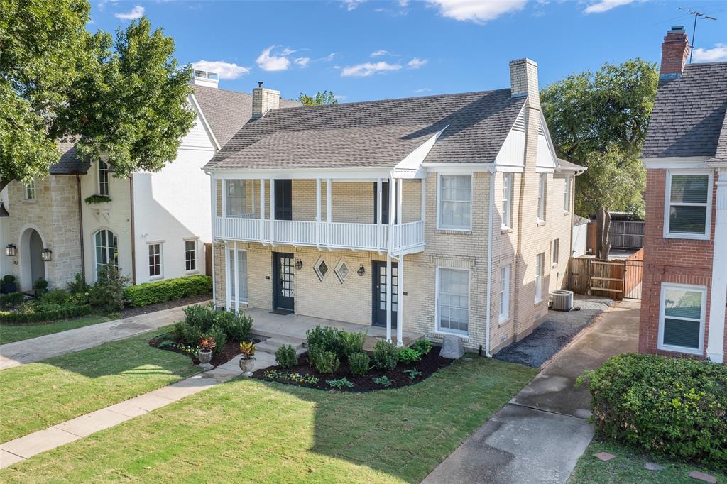 Two-story brick exterior featuring a full-width upper balcony, dual entryways, diamond-patterned accent windows, and a steep gable roofline Two-story brick exterior featuring a full-width upper balcony, dual entryways, diamond-patterned accent windows, and a steep gable roofline