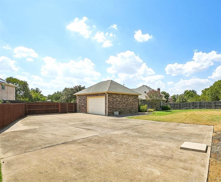 Extra large parking space behind the privacy gate for all your vehicles with additional space for an inground pool.