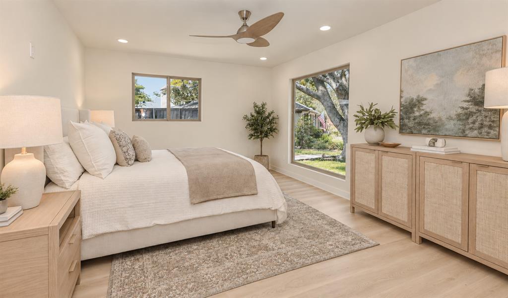 Light wood-finish flooring, recessed lighting, and a ceiling fan with integrated lighting