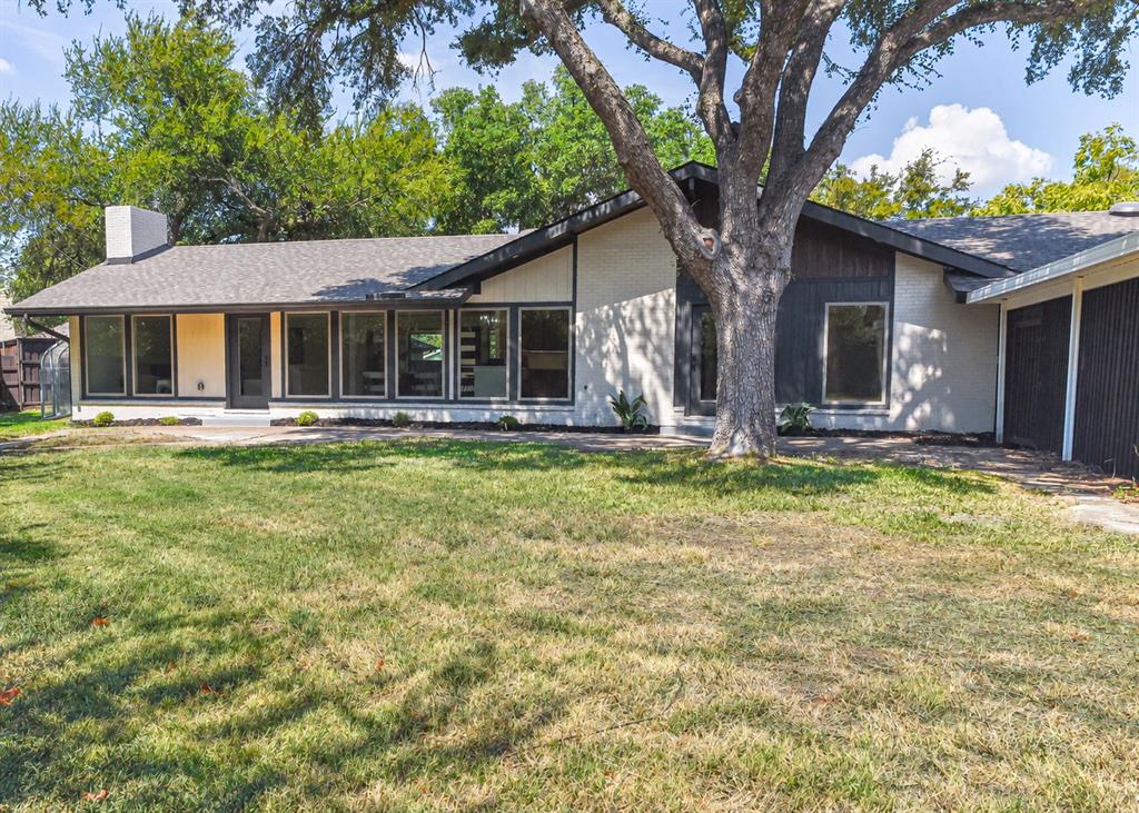 Large grassy backyard with greenhouse at one end and 2+ car carport-with room for your golfcart & attached storage building at the other end