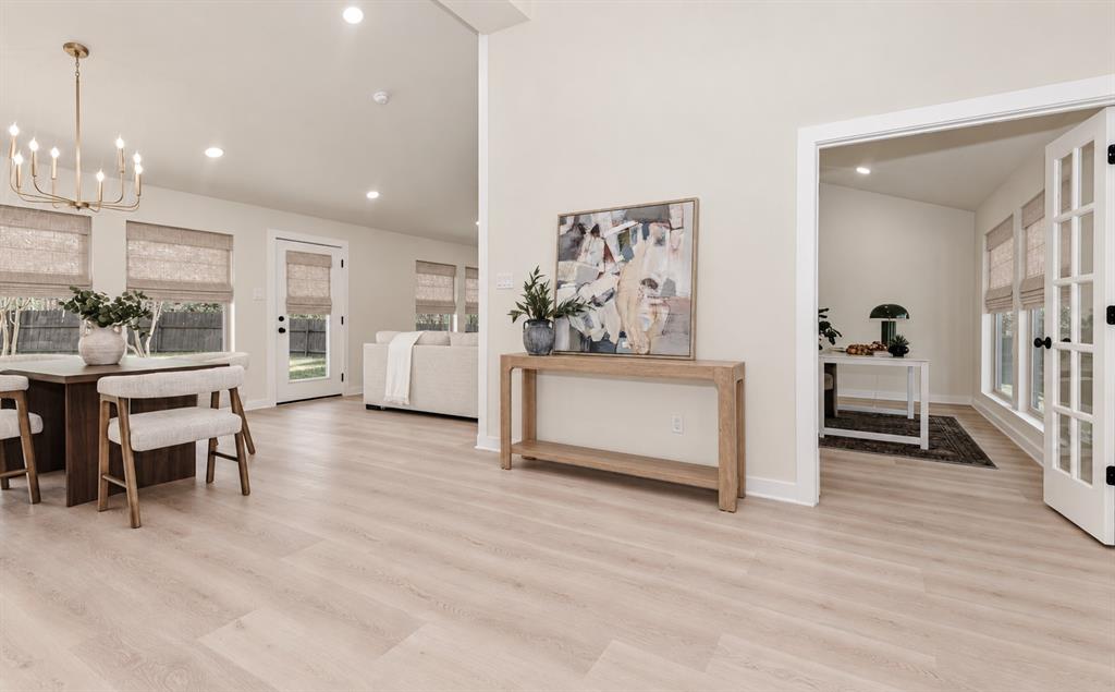 Light wood-finish flooring throughout, vaulted ceilings, recessed lighting, and French doors create an open feeling Light wood-finish flooring throughout, vaulted ceilings, recessed lighting, and French doors create an open feeling