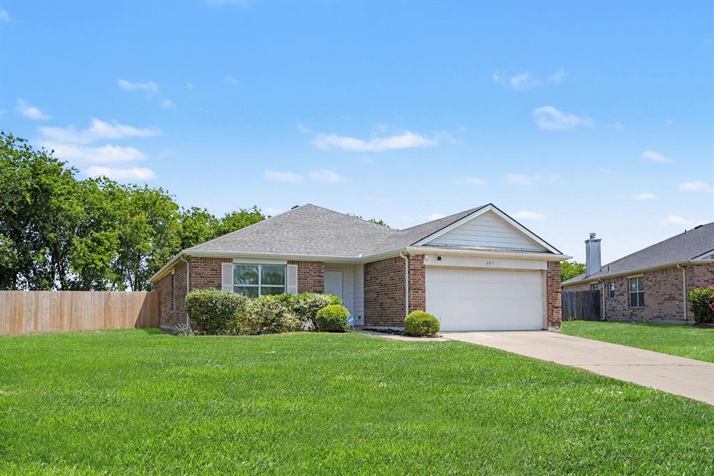 Charming brick ranch home featuring a spacious two-car attached garage, manicured lawn, and mature landscaping