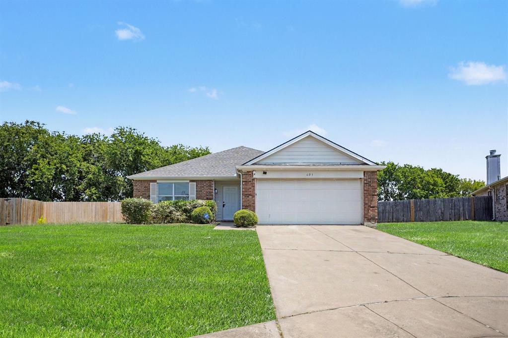 Charming one-story brick residence featuring a welcoming front elevation with peaked roofline, blue entry door, and two-car garage